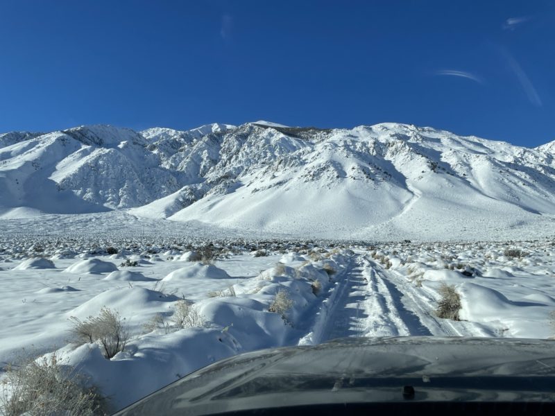 Snowy, rutted approach towards Mt. Tom dressed in white