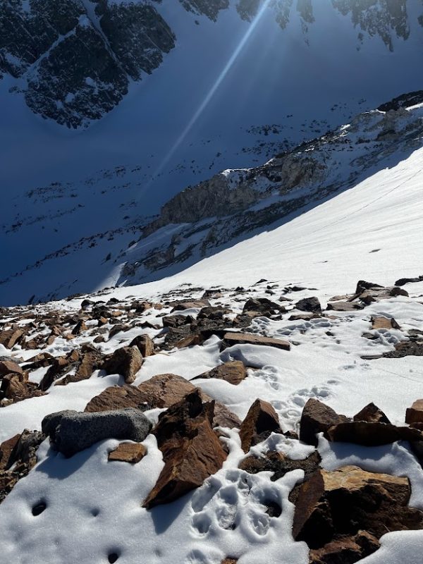 Foreground: Melt Freeze crust on the surface of a steep S facing slope above treeline (11800'). Background: softer loose snow in wind protected and shaded terrain above treeline